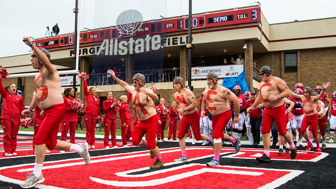 Elite Lettermen and Football Team run onto the field