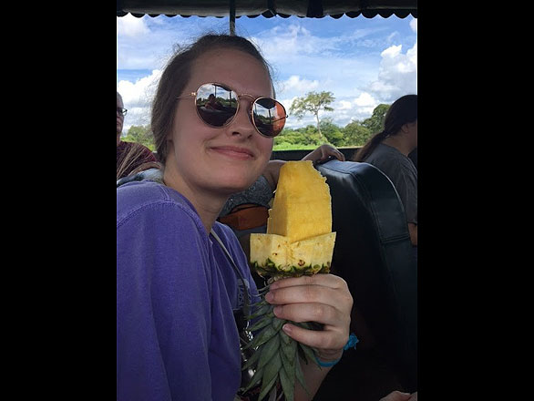Alyson Matthews eating a pineapple popsicle on the pineapple farm.