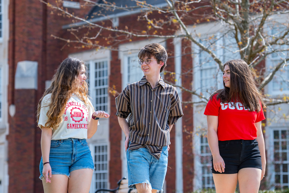 JSU Honors students walking and talking in front of Angle Hall.