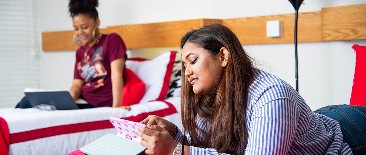Students studying on bed