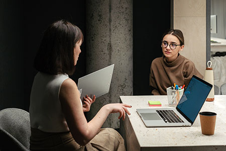 supervisor and employee sitting at conference table