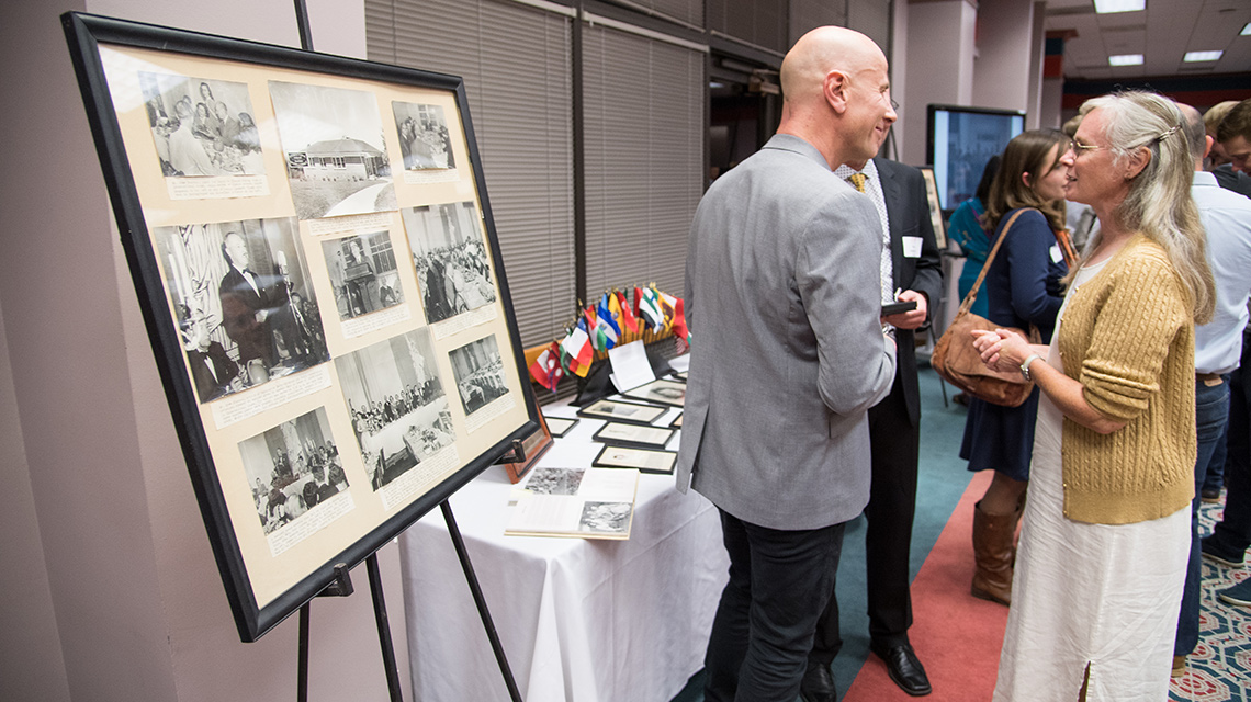 Reunion Attendees visit next to a table of memorabilia