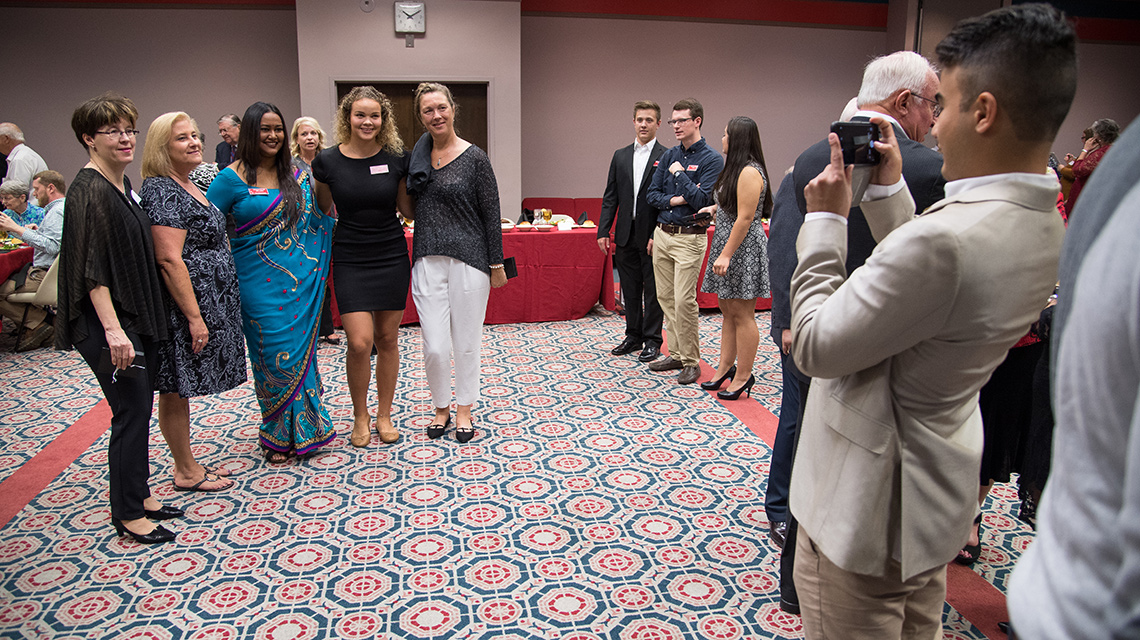 Current and past IH students take advantage of a photo opportunity at a past reunion