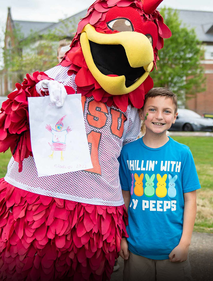 Cocky shows off a portrait of himself that was painted by a young fan