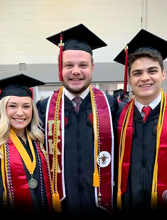 Philip Tice, center, with friends at graduation