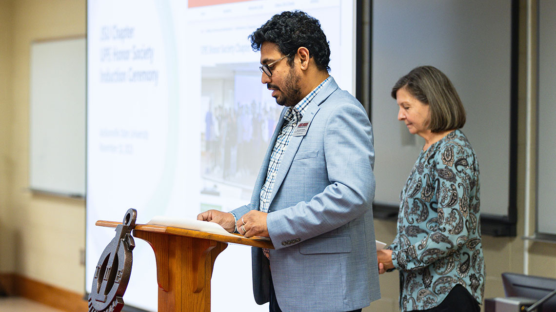 Dr Ghosh presenting with Dr Case in the background