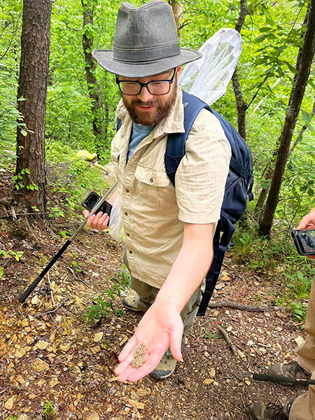 A park employee holds a toad