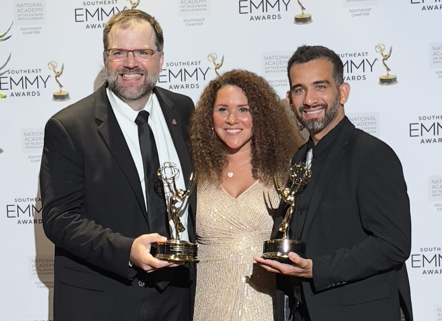 Seth Johnson holding Emmy Awards