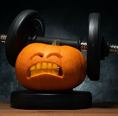 Pumpkin lifting weights