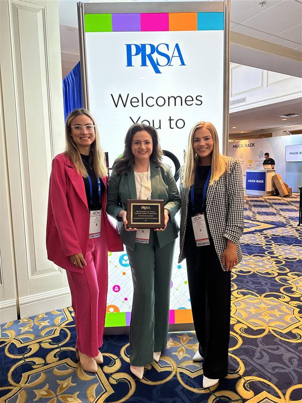 PRSSA students Ann Manning (left) and Madison Parker (right) with Dr. Breann Murphy.