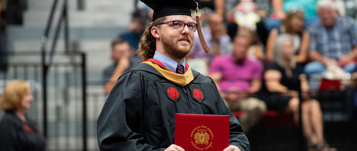 Graduate student at hooding ceremony