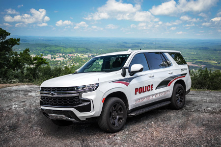A JSU Police cruiser SUV parked atop Chimney Peak on a clear day, with the campus below