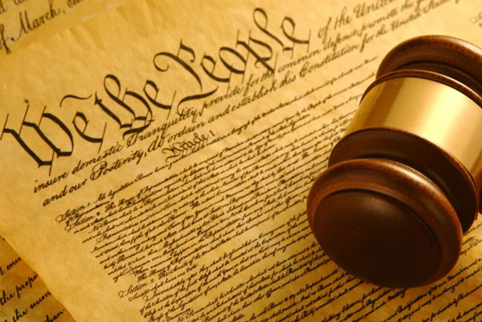 The United States Constitution with a gavel lying on top of it