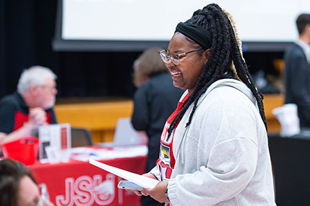 A student browsing a career fair