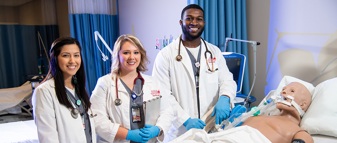 Respiratory therapy students in lab with simulated patient