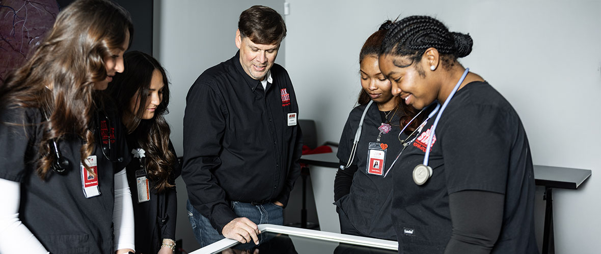 Respiratory therapy students in lab with simulated patient