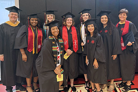 JSU Social Work faculty with a group of graduates on commencement day