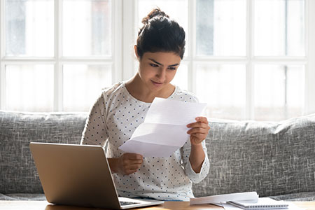 A female student looks at her acceptance letter