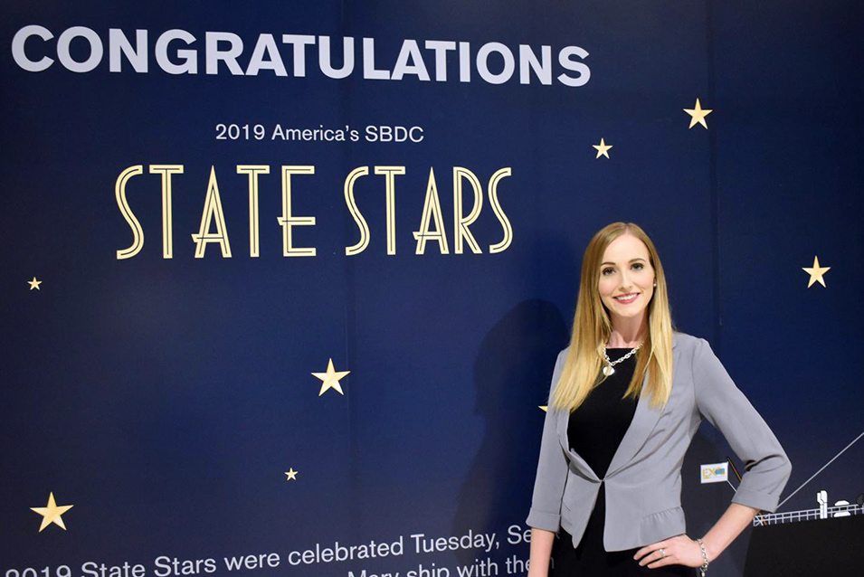 Cassie Chandler standing in front of the banner designating her a State star