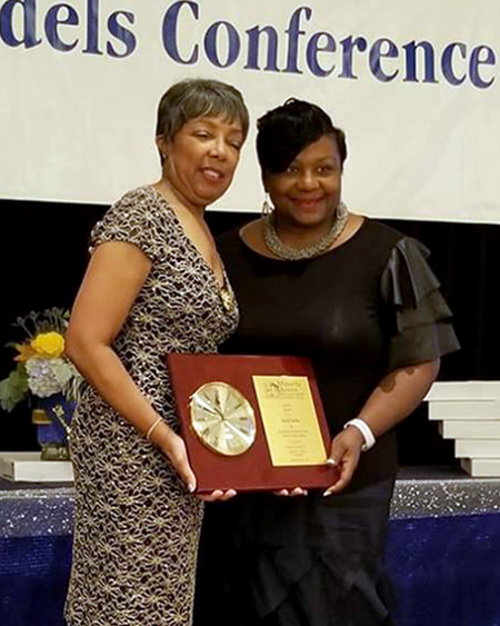 Charlcie Vann receives an award