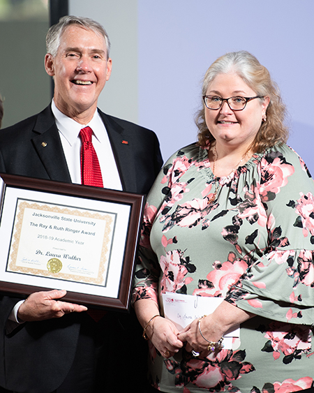 Then JSU President John Beehler awards Doctor Laura Walker with the Ringer Award for Faculty Development in 2019.