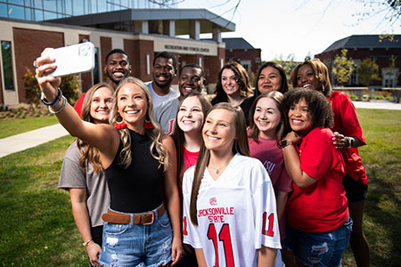 Students taking selfie outside recreation center