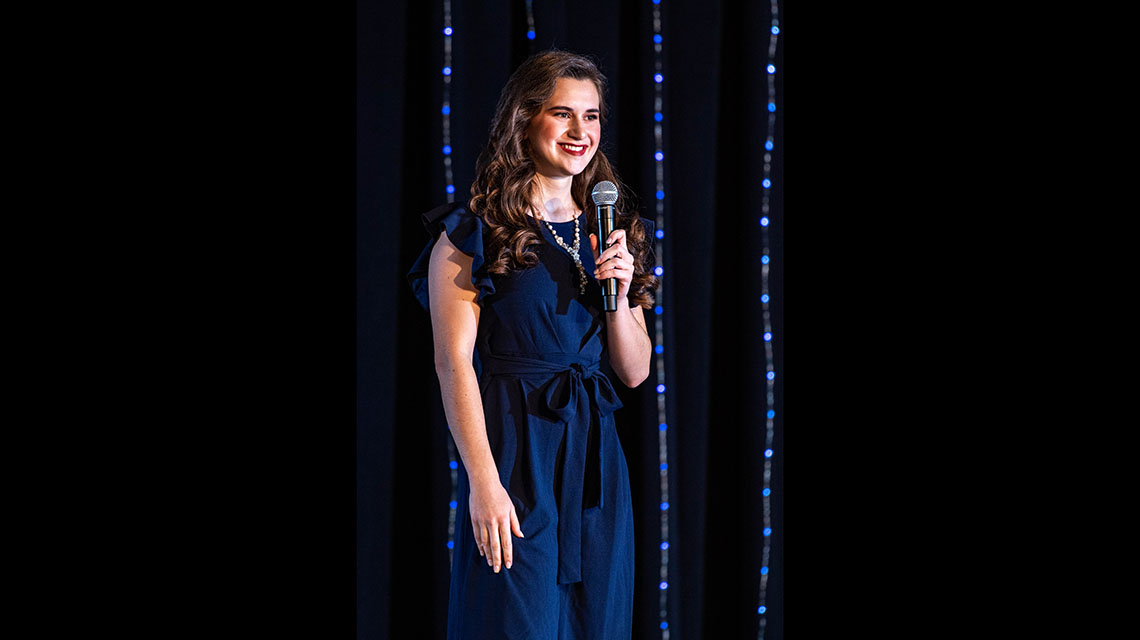 A contestant wearing a blue dress