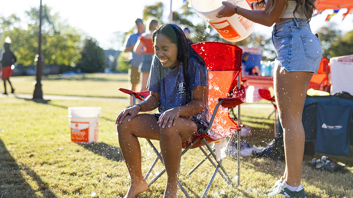 Student getting splashed by bucket of water
