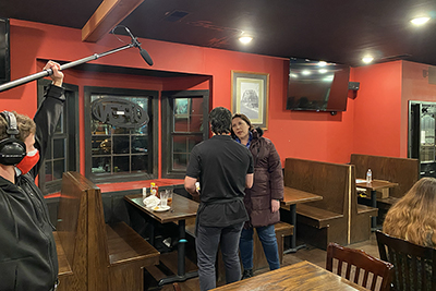 on a film set a man and a woman appear to be arguing