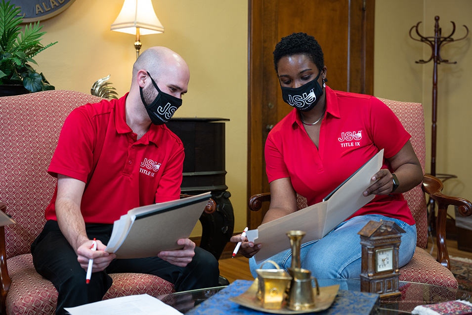 Two Deputy Advisors looking at folder