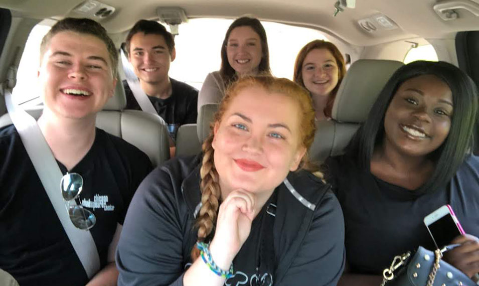 Students in car posing for photo