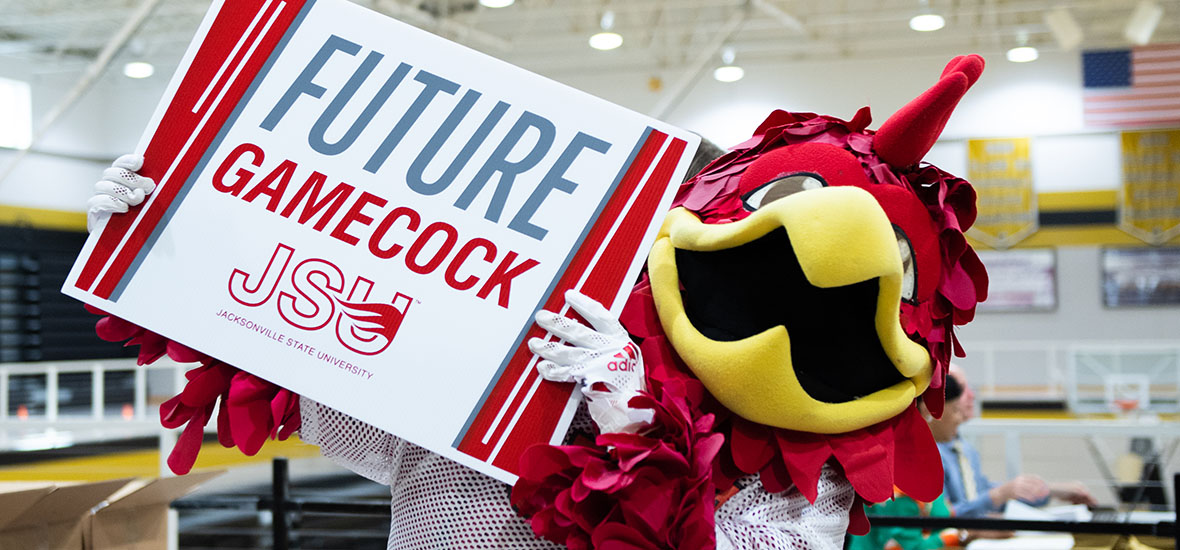 Cocky holding up a future Gamecock sign