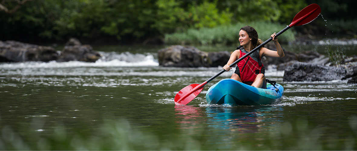 A female student kayaks on scenic Terrapin Creek