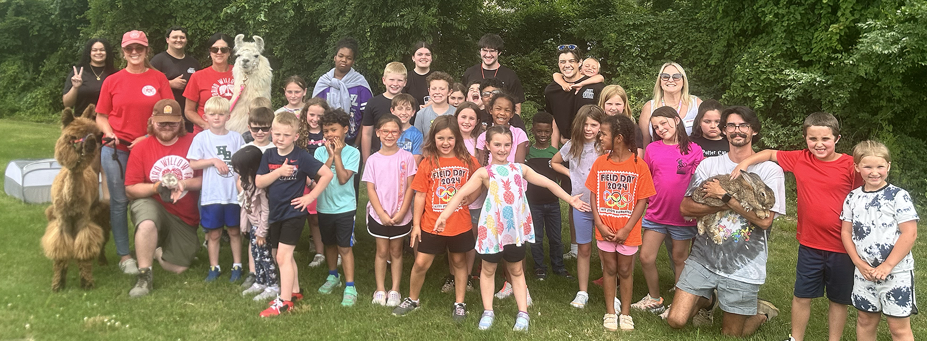 A group of children and camp counselors at the UREC Petting Zoo Event