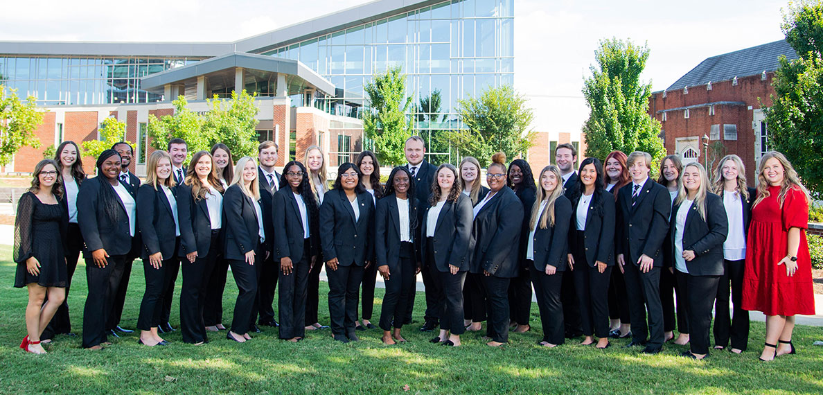 2023-2024 Ambassadors in front of the rec center and Kenner Hall