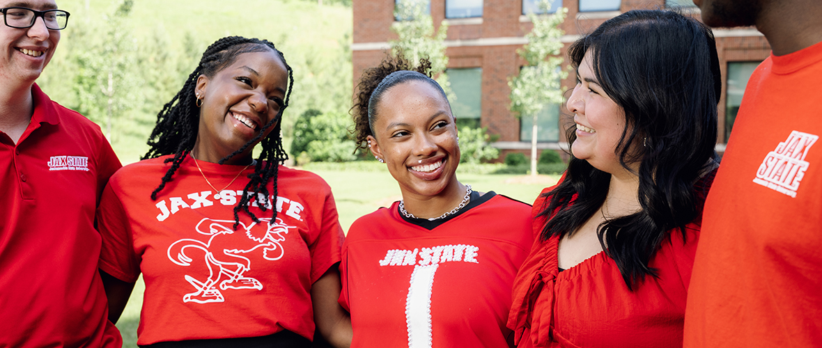 Three JSU Ambassadors on Houston Cole Library observation deck, with a view of the west side of campus behind them.
